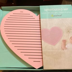 Pearhead light pink heart shaped letter board. White letters to write messages.